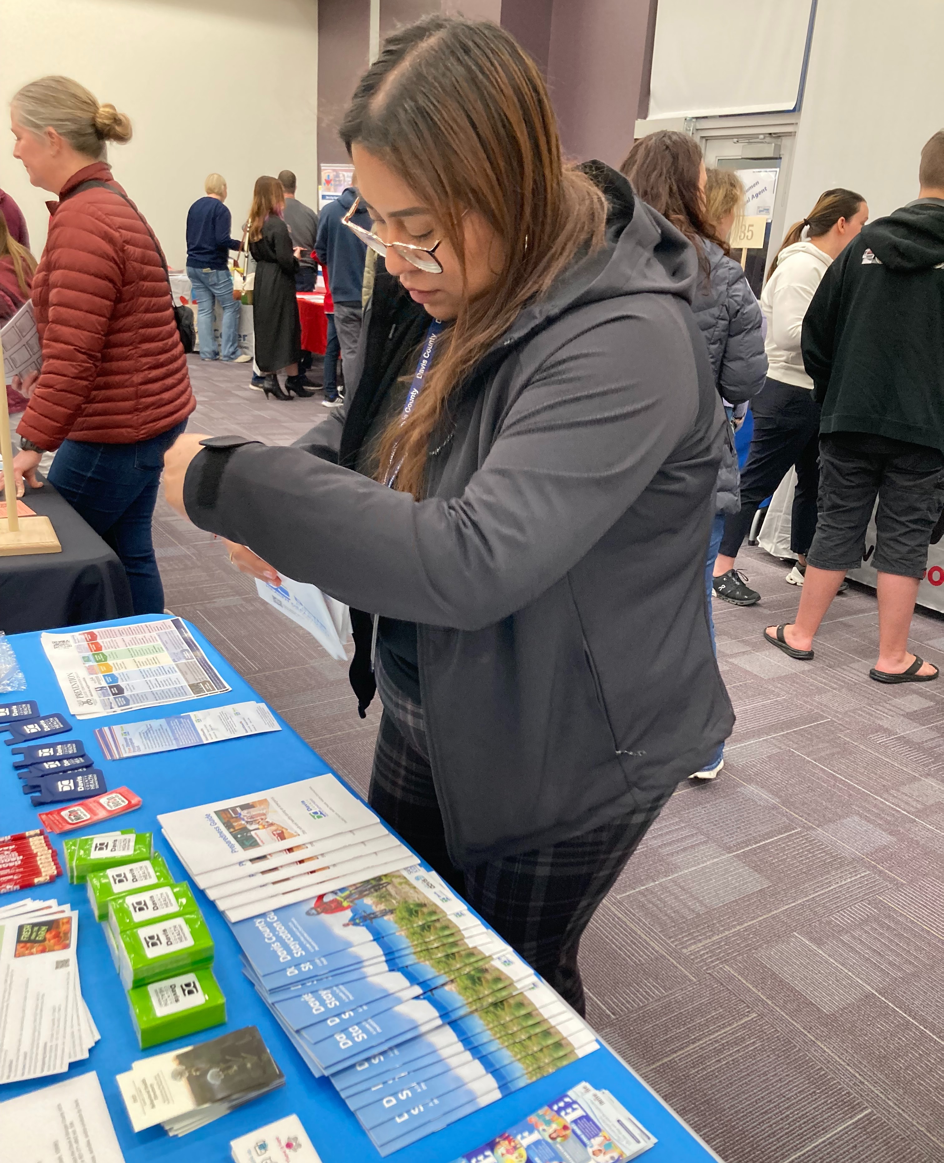 Woman looking at resources on a table at a Davis School District transition fair